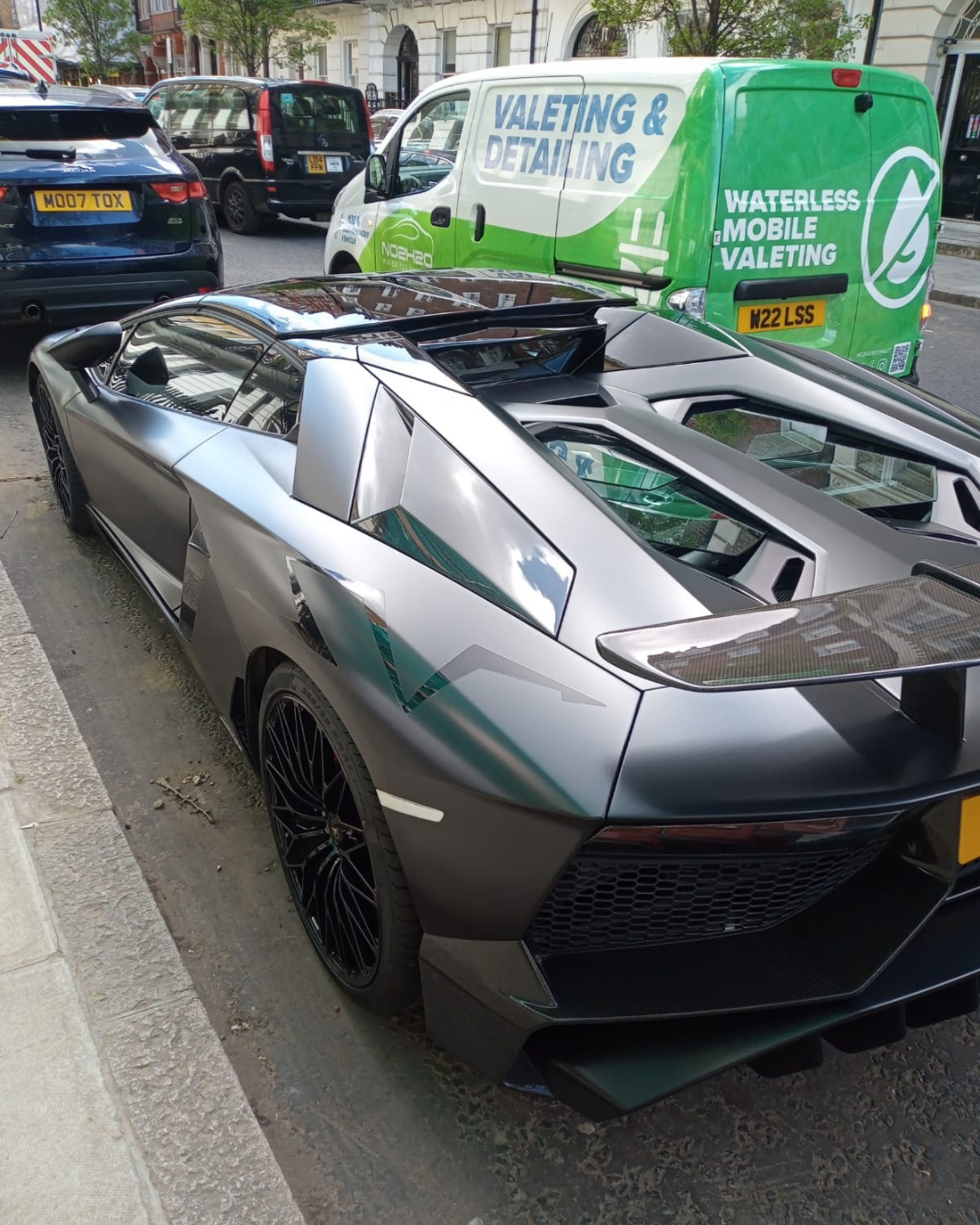 NO2H2O electric valeting van behind a Lamborghini Aventador on a West London street