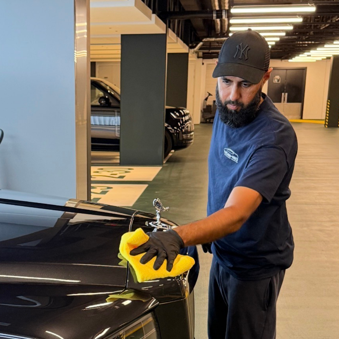 Shaf, founder of NO2H2O, hand-detailing a Rolls-Royce
