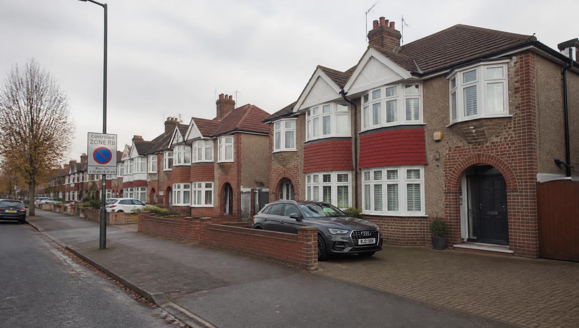 Suburban Hounslow street with cars parked on driveways